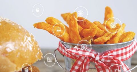 Crispy sweet potato fries in rustic tin pail with red gingham ribbon and sesame bun