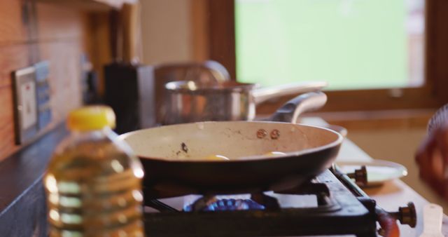 Frying Pan with Eggs on a Stove in Cozy Kitchen - Download Free Stock Images Pikwizard.com