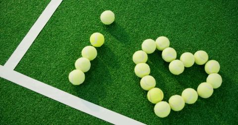 Tennis Balls Forming 'I Love' Shape on Court with White Line