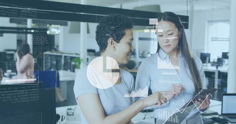 Businesswomen Collaborating with Digital Data Analytics in Office Setting