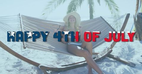 Cheerful Woman on Beach Hammock Celebrating 4th of July