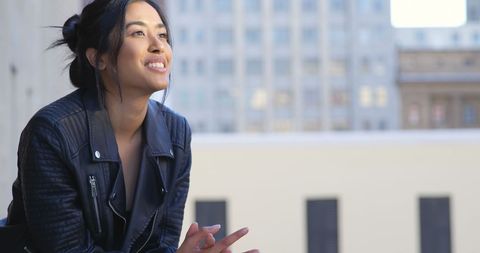 Confident Businesswoman Smiling on Urban Office Balcony