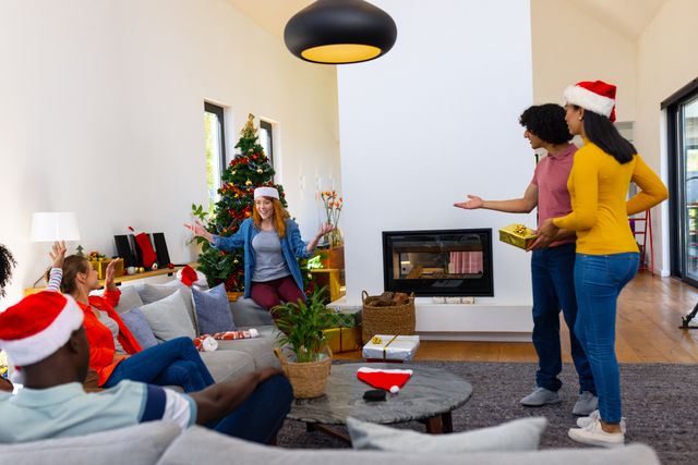 Diverse group of friends celebrating Christmas in a cozy living room, exchanging gifts and enjoying each other's company. Perfect for holiday-themed promotions, advertisements, and social media posts highlighting friendship, togetherness, and festive spirit.