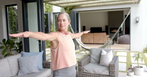 Caucasian Senior Woman Practicing Yoga in Modern Outdoor Setting