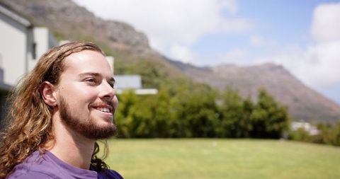 Young Man with Long Hair Enjoying Outdoor Scenery