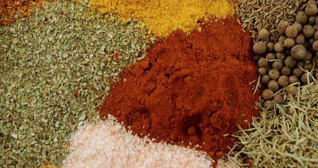 Various spices and herbs placed together, creating a vivid and textured composition. Perfect for cookbooks, food blogs, culinary websites, cooking class promotions, and restaurant menu designs.