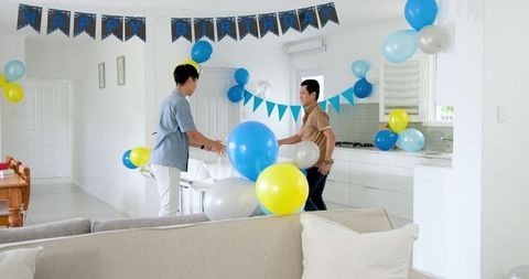 Father and son celebrating birthday with decorations and cake