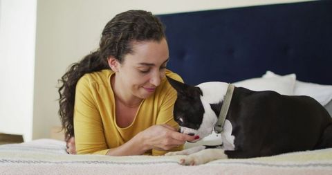 Woman enjoying relaxed time at home with her boston terrier