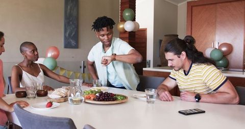 Friends Preparing Meal Together During Home Celebration Gathering