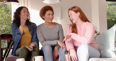 Diverse Friends Relaxed Conversation Over Coffee at Home
