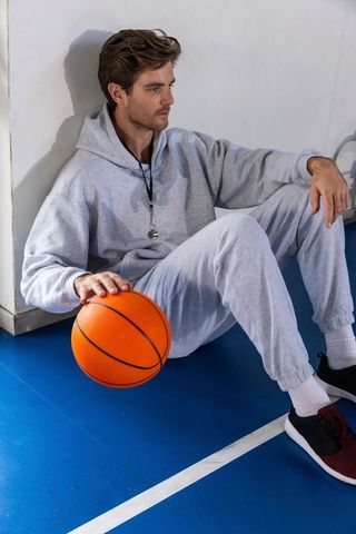 Athlete Resting Basketball Floor Casual Sportswear Motivation