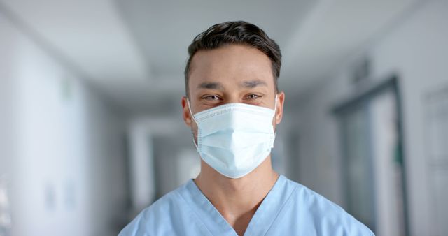 Young Healthcare Worker Wearing Surgical Mask in Hospital Corridor - Download Free Stock Images Pikwizard.com