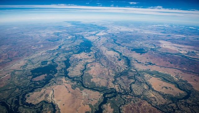 Aerial panorama showing braided river basin, reservoirs, irrigated fields and settlements