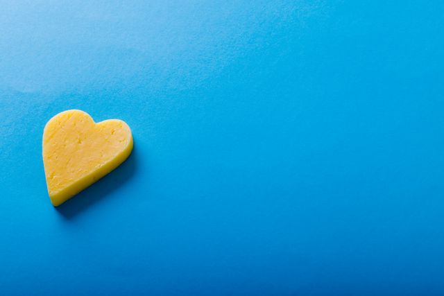 High angle view on heart shaped on blue background with copy space. unaltered, food, studio shot, love and dairy product.