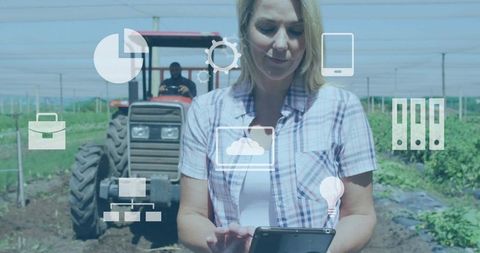 Woman farmer using tablet for precision agriculture management with tractor and data icons