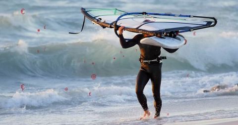 Energetic Windsurfer Carrying Board on Ocean Beach