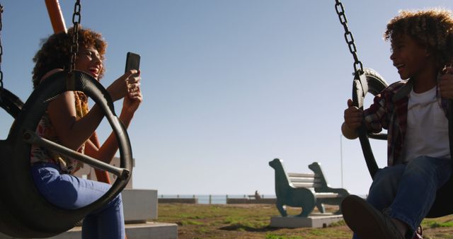 Mother and Son Enjoying Swing Time at Playground - Download Free Stock Images Pikwizard.com