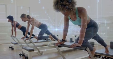 Group pilates reformers exercise in modern studio promotes fitness and wellbeing