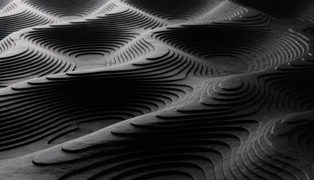 Layered Topography Sculpture with Concentric Ridges and Dramatic Monochrome Shadows