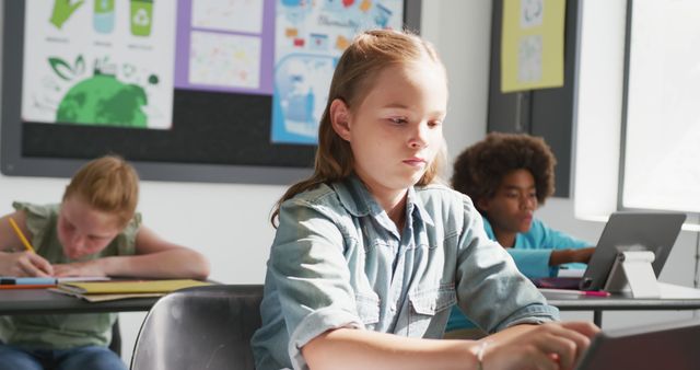 Focused Students Using Tablets and Writing in Classroom - Download Free Stock Images Pikwizard.com