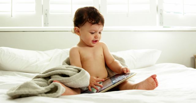 Curious Toddler Playing with Tablet on Bed - Download Free Stock Images Pikwizard.com