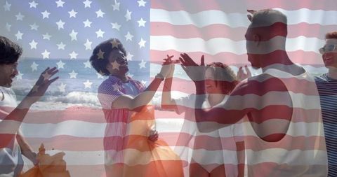 Friends celebrating fourth of july on beach with american flag overlay