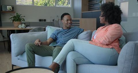 African American Couple Relaxing in Modern Living Room Setting