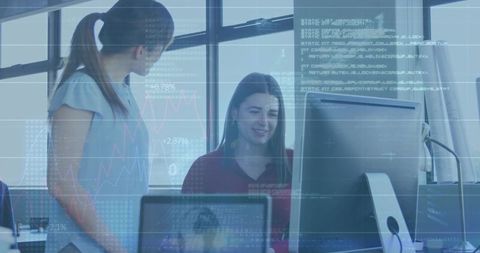 Collaborating Women at Desktop with Financial Charts and Code Overlays for Tech Teamwork