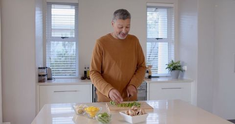 Senior Man Preparing Fresh Vegetables in Modern Kitchen for Healthy Living