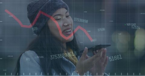 Asian Woman Analyzing Financial Data on Smartphone Outdoors