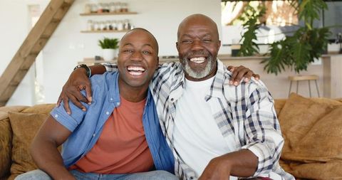 Joyful Father and Son Sharing Loving Bond on Comfortable Couch
