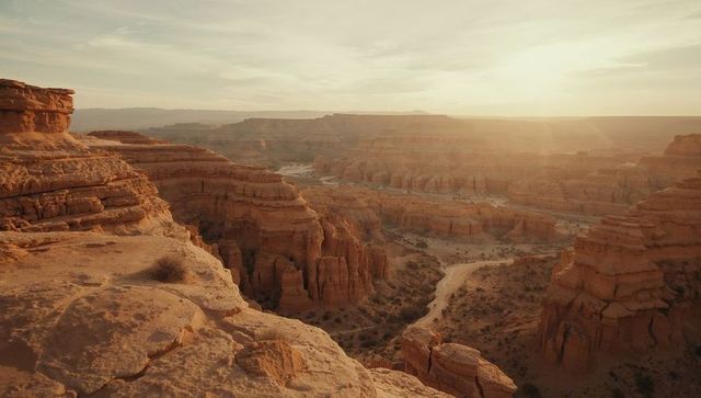 Desert Canyon Landscape with Sandstone Cliffs and Hoodoos at Sunset