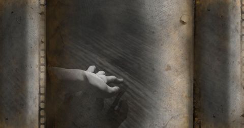 Creepy hand in digital fog with vintage film overlay