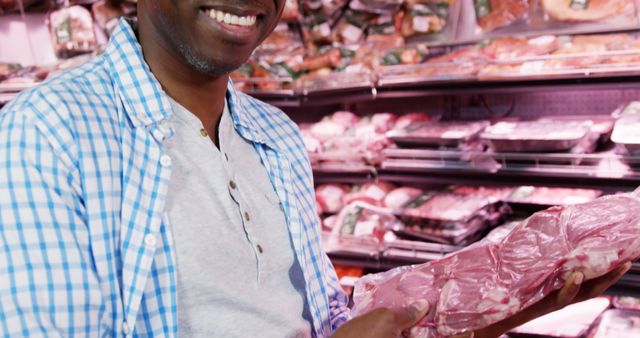 Middle-aged Man Holding Packaged Meat in Grocery Store - Download Free Stock Images Pikwizard.com