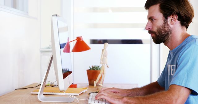 Young Man Working on Computer in Home Office - Download Free Stock Images Pikwizard.com