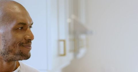 African american man in contemporary home kitchen with minimalist design