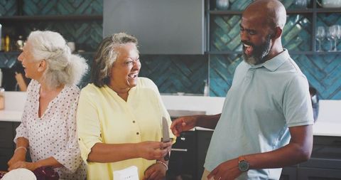 Diverse Friends Sharing Laughter in Modern Kitchen