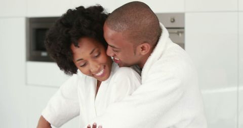 Affectionate Couple Embracing in Modern Kitchen