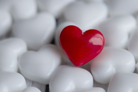 Red Heart Among White Hearts Representing Love and Uniqueness