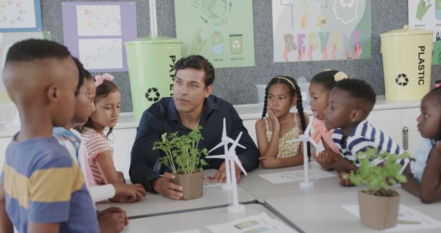 Teacher Demonstrating Plant and Wind Turbines to Diverse Group of Children in Classroom - Download Free Stock Images Pikwizard.com