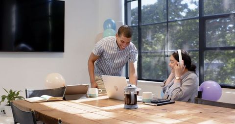 Joyful office celebration with colleagues sharing cake