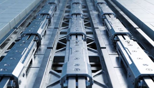 Precision linear guide rails and carriage blocks on industrial machine bed for automation