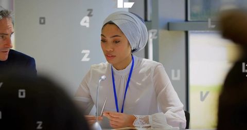 Confident professional woman participating in business meeting