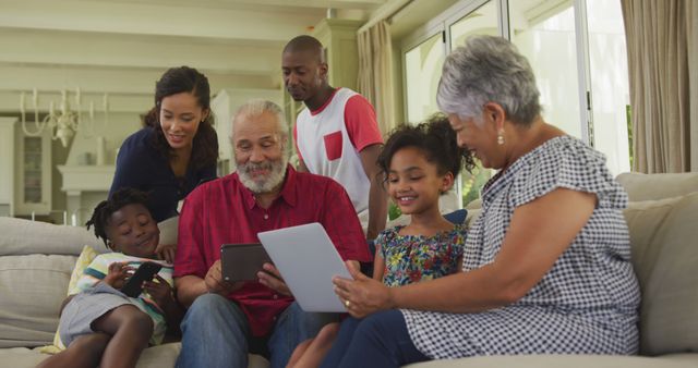 Happy Multigenerational Family Using Digital Tablets and Phones at Home - Download Free Stock Images Pikwizard.com