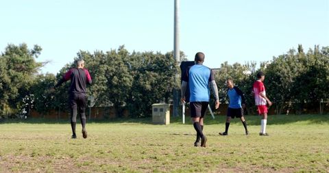 Diverse soccer players strategically positioning on field