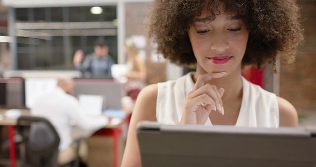 Woman Working on Tablet in Modern Office Environment - Download Free Stock Images Pikwizard.com