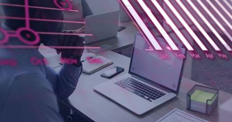 Open Laptop on Office Desk with Magenta Chart Reflection, Team Collaboration and Workflow