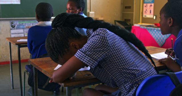 Stressed Student with Head Down in Classroom - Download Free Stock Images Pikwizard.com