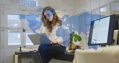 Businesswoman Analyzing Global Business Data on Laptop at Office