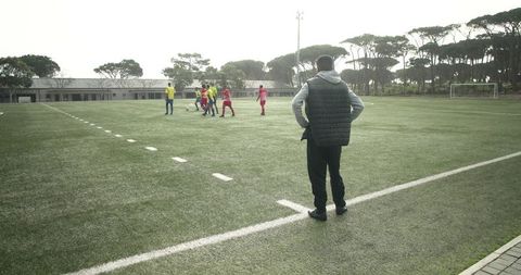Soccer Coach Observing Youth Team on Pitch - Download Free Stock Images Pikwizard.com